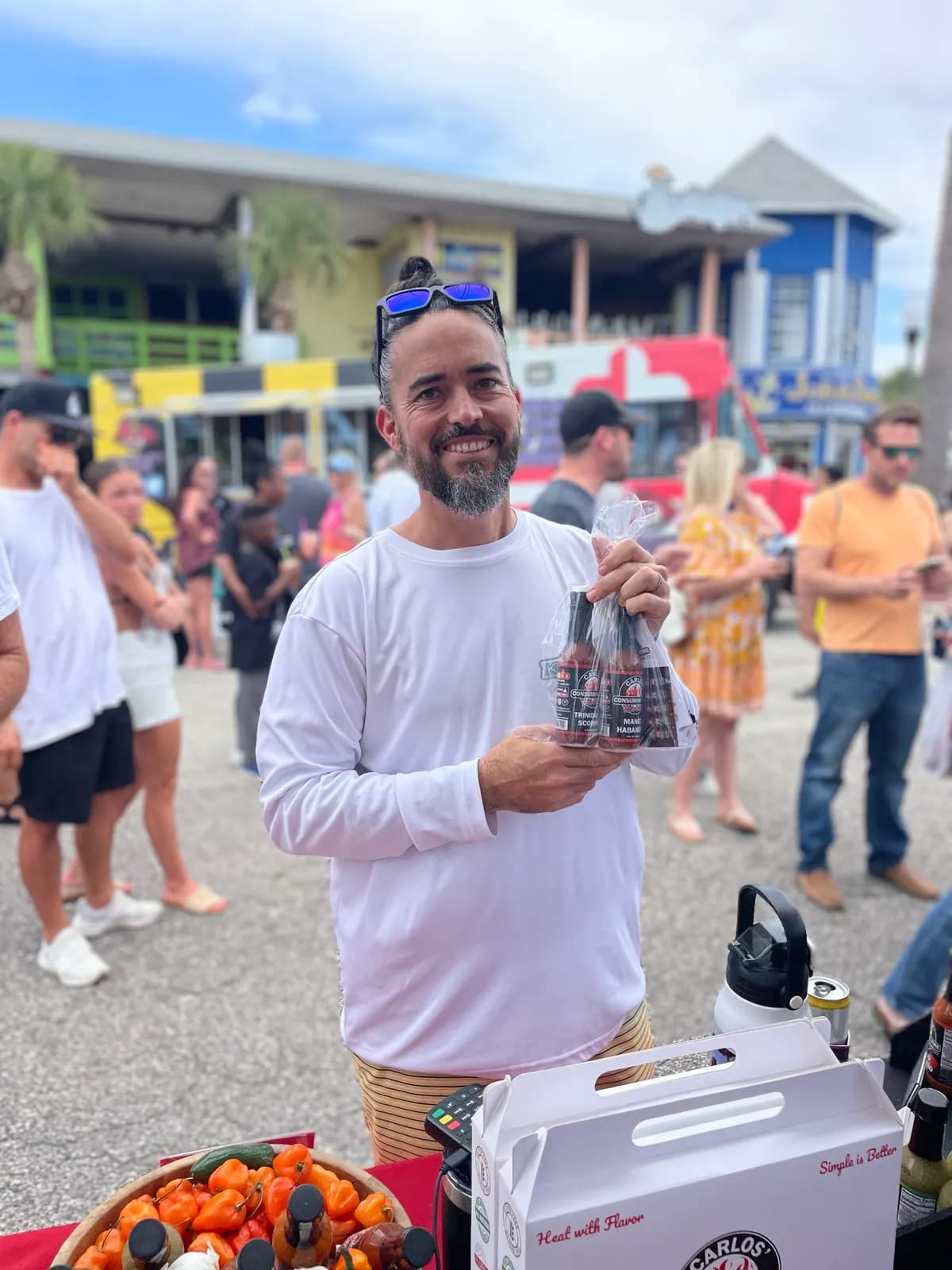 Customer holding a wrapped multi-bottle gift pack at the festival booth