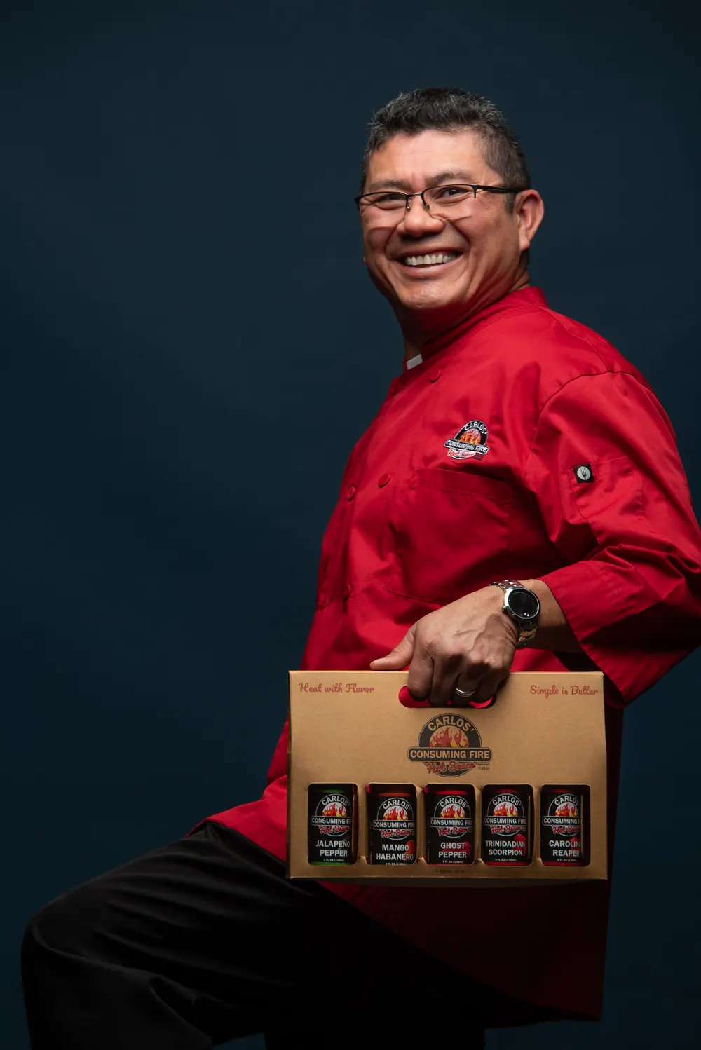 Carlos carrying the five-bottle gift box of all five sauces